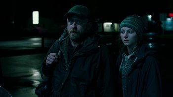 Movie still from “Leave No Trace” (2018), directed by Debra Granik – A man and a woman standing next to each other in the dark; Medium shot, Low angle