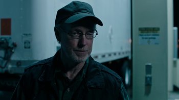 Movie still from “Leave No Trace” (2018), directed by Debra Granik – A person wearing glasses and a hat; Close Up shot, Over the shoulder angle