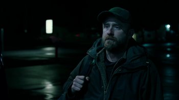 Movie still from “Leave No Trace” (2018), directed by Debra Granik – A man with a beard wearing a hat and a jacket; Medium shot, Over the shoulder angle