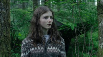 Movie still from “Leave No Trace” (2018), directed by Debra Granik – A woman standing in the middle of a forest; Close Up shot, Low angle