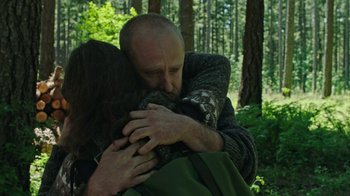 Movie still from “Leave No Trace” (2018), directed by Debra Granik – A man and woman hugging in the woods; Medium shot, Over the shoulder angle