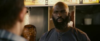 A man with a beard is posing for a picture
