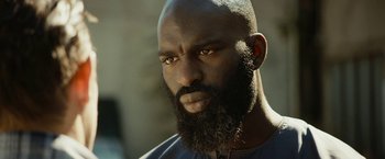 A man with a beard is looking at the camera
