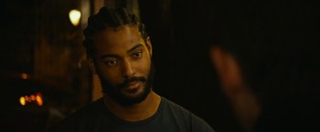 A person with dreadlocks looking at the camera
