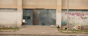 Movie still from “Les Misérables” (2019), directed by Ladj Ly – A fire hydrant on the side of a building; Extreme Wide shot, High angle
