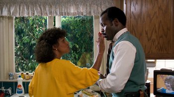 Movie still from “Lethal Weapon” (1987), directed by Richard Donner – A man and a woman touching their faces; Medium shot, Over the shoulder angle