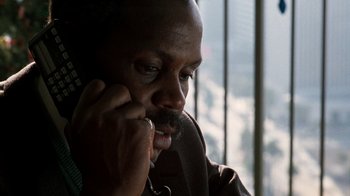 Movie still from “Lethal Weapon” (1987), directed by Richard Donner – A person talking on a cell phone; Close Up shot, Low angle