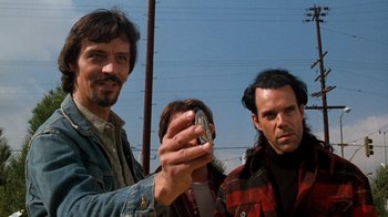 Movie still from “Lethal Weapon” (1987), directed by Richard Donner – A group of men standing next to each other; Close Up shot, Low angle