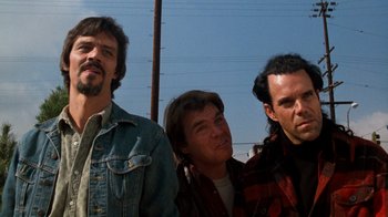 Movie still from “Lethal Weapon” (1987), directed by Richard Donner – A group of men standing next to each other; Close Up shot, Low angle