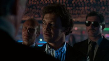 Movie still from “Lethal Weapon” (1987), directed by Richard Donner – A person wearing a suit and tie; Close Up shot, Low angle