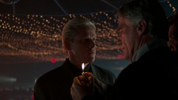 Movie still from “Lethal Weapon” (1987), directed by Richard Donner – A man holding a lit candle in his hand; Close Up shot, Low angle