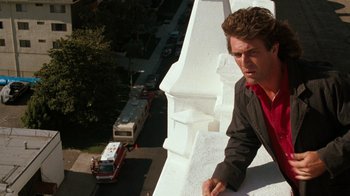 Movie still from “Lethal Weapon” (1987), directed by Richard Donner – A man leaning up against the side of a building; Close Up shot, Low angle