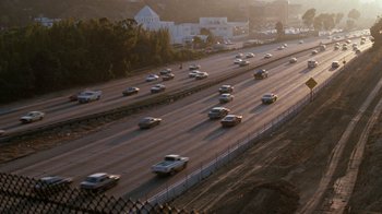 Movie still from “Lethal Weapon” (1987), directed by Richard Donner – A bunch of cars that are on a freeway; Extreme Wide shot, High angle