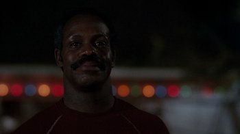 Movie still from “Lethal Weapon” (1987), directed by Richard Donner – A person wearing a red shirt; Close Up shot, Low angle