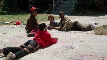 Movie still from “Lethal Weapon” (1987), directed by Richard Donner – A group of kids sitting on the ground; Wide shot, High angle