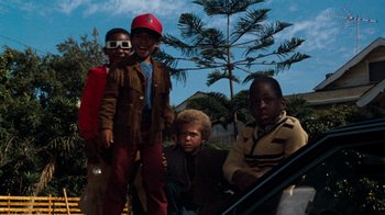 Movie still from “Lethal Weapon” (1987), directed by Richard Donner – A group of young boys sitting next to each other; Medium shot, Low angle