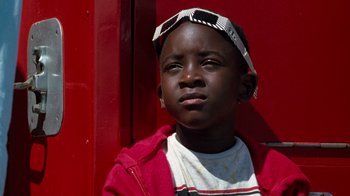 Movie still from “Lethal Weapon” (1987), directed by Richard Donner – A young boy wearing a red jacket and a white hat; Close Up shot, Low angle
