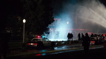 Movie still from “Lethal Weapon” (1987), directed by Richard Donner – A group of people are standing in the street; Extreme Wide shot, High angle