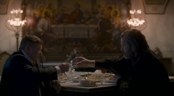 Movie still from “Leviathan” (2014), directed by Andrey Zvyagintsev – Two people sitting at a table with food; Medium shot, Over the shoulder angle