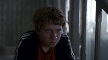 Movie still from “Leviathan” (2014), directed by Andrey Zvyagintsev – A young man is sitting in front of a window; Close Up shot, Over the shoulder angle