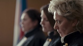 Movie still from “Leviathan” (2014), directed by Andrey Zvyagintsev – A group of people sitting next to each other in a room; Close Up shot, Low angle