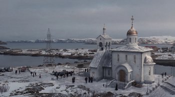 Movie still from “Leviathan” (2014), directed by Andrey Zvyagintsev – A group of people standing outside of a church near a body of water; Extreme Wide shot, High angle