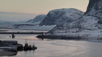 Movie still from “Leviathan” (2014), directed by Andrey Zvyagintsev – Two boats in a body of water with a mountain in the background; Extreme Wide shot, Low angle