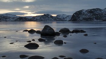 Movie still from “Leviathan” (2014), directed by Andrey Zvyagintsev – A body of water that has some rocks in the water; Extreme Wide shot, High angle