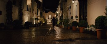 Movie still from “Kingsman: The Golden Circle” (2017), directed by Matthew Vaughn – A person running down a street at night; Extreme Wide shot, High angle