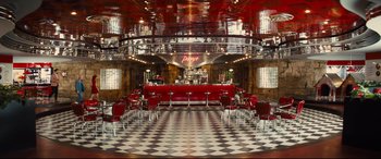 Movie still from “Kingsman: The Golden Circle” (2017), directed by Matthew Vaughn – A restaurant with red chairs and checkerboard floors; Extreme Wide shot, High angle