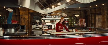 Movie still from “Kingsman: The Golden Circle” (2017), directed by Matthew Vaughn – A woman standing in front of a counter in a kitchen; Medium shot, Low angle