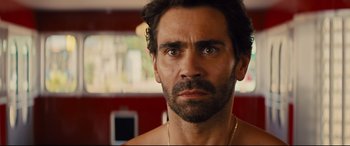 Movie still from “Kingsman: The Golden Circle” (2017), directed by Matthew Vaughn – A person with a beard; Close Up shot, Over the shoulder angle