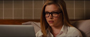 Movie still from “Kingsman: The Golden Circle” (2017), directed by Matthew Vaughn – A woman wearing glasses looking at the camera; Close Up shot, Over the shoulder angle