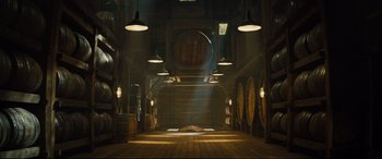 Movie still from “Kingsman: The Golden Circle” (2017), directed by Matthew Vaughn – A room filled with lots of wooden barrels; Extreme Wide shot, Low angle