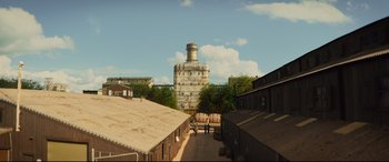 Movie still from “Kingsman: The Golden Circle” (2017), directed by Matthew Vaughn – An image of an old building in the middle of the day; Extreme Wide shot, High angle