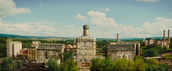 Movie still from “Kingsman: The Golden Circle” (2017), directed by Matthew Vaughn – An aerial view of an old building with a sky background; Extreme Wide shot, High angle