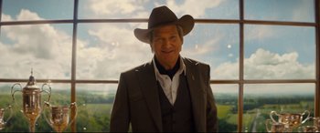 Movie still from “Kingsman: The Golden Circle” (2017), directed by Matthew Vaughn – An older man in a suit and a cowboy hat; Medium shot, Low angle