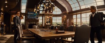 Movie still from “Kingsman: The Golden Circle” (2017), directed by Matthew Vaughn – A large wooden table in the middle of a room; Wide shot, Low angle