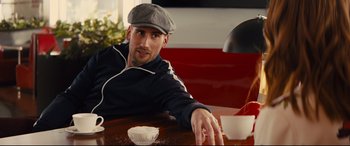 Movie still from “Kingsman: The Golden Circle” (2017), directed by Matthew Vaughn – A man sitting at a table with a bowl in front of him; Medium shot, Low angle