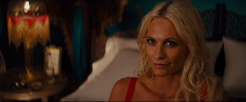 Movie still from “Kingsman: The Golden Circle” (2017), directed by Matthew Vaughn – A beautiful blonde woman sitting on a bed; Close Up shot, High angle