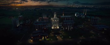Movie still from “Kingsman: The Golden Circle” (2017), directed by Matthew Vaughn – An aerial view of an industrial building at night; Extreme Wide shot, High angle