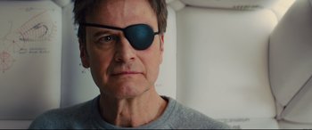 Movie still from “Kingsman: The Golden Circle” (2017), directed by Matthew Vaughn – A person wearing a eye patch; Close Up shot, Low angle