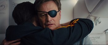 Movie still from “Kingsman: The Golden Circle” (2017), directed by Matthew Vaughn – A person wearing a eye patch; Close Up shot, Over the shoulder angle