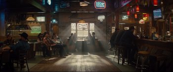 Movie still from “Kingsman: The Golden Circle” (2017), directed by Matthew Vaughn – A group of people sitting around a table in a room; Wide shot, High angle