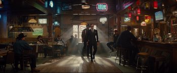 Movie still from “Kingsman: The Golden Circle” (2017), directed by Matthew Vaughn – A couple of men in suits walking in a room; Wide shot, Low angle