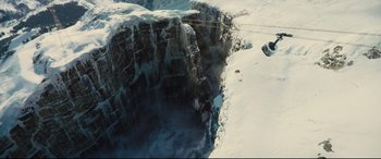 Movie still from “Kingsman: The Golden Circle” (2017), directed by Matthew Vaughn – A view of a cliff from above in the snow; Extreme Wide shot, Overhead angle