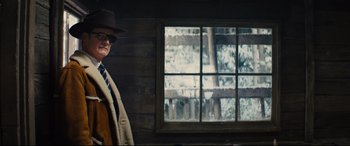 Movie still from “Kingsman: The Golden Circle” (2017), directed by Matthew Vaughn – A man standing in front of a window with snow on it; Medium shot, Low angle