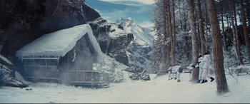 Movie still from “Kingsman: The Golden Circle” (2017), directed by Matthew Vaughn – A cabin in the snow with a mountain in the background; Extreme Wide shot, Low angle