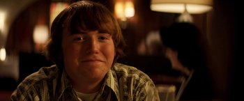 Movie still from “Licorice Pizza” (2021), directed by Paul Thomas Anderson – A person sitting in front of a window; Close Up shot, Low angle