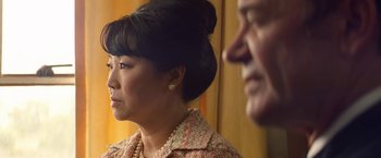 Movie still from “Licorice Pizza” (2021), directed by Paul Thomas Anderson – An older man and a younger woman sitting next to each other; Close Up shot, Over the shoulder angle